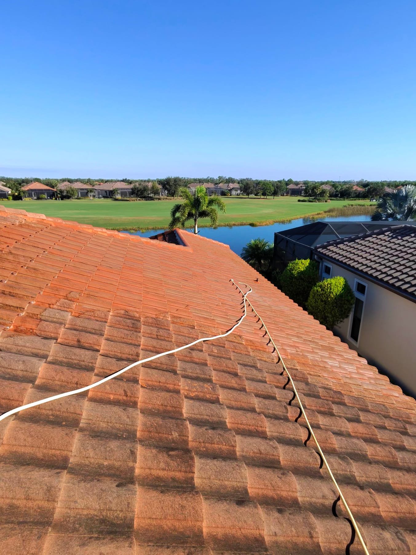 Tile roof cleaning half cleaned showing before and after difference